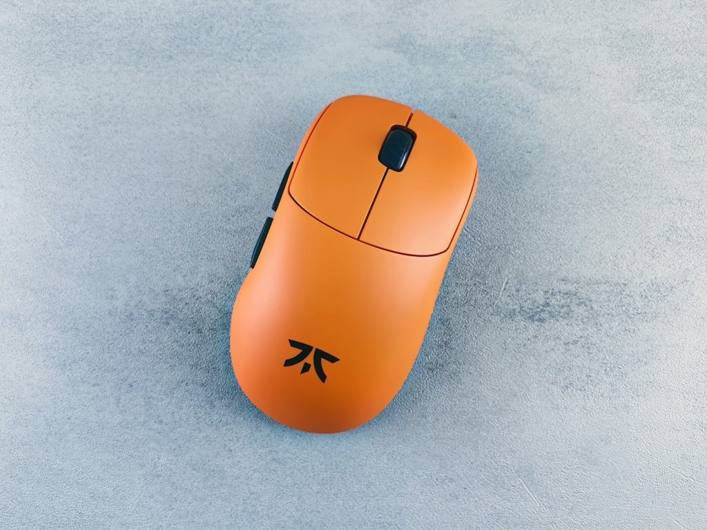 A computer mouse sitting on top of a blue surface